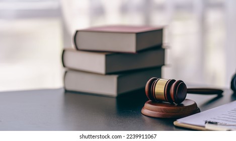 Lawyer or judge's hammer in court The auction hammer is on the woo table. Legal subject or auction company with book sign in office - Shutterstock ID 2239911067