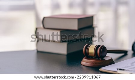 Lawyer or judge's hammer in court The auction hammer is on the woo table. Legal subject or auction company with book sign in office