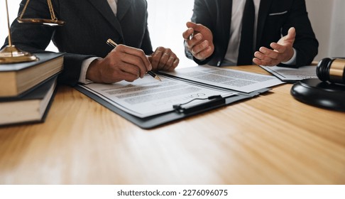 Lawyer, legal advisor, businessman brainstorming clarifying agreement details business contract Joint financial investments in office real estate projects. - Shutterstock ID 2276096075