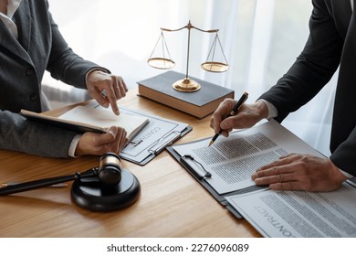 Lawyer, legal advisor, businessman brainstorming information on agreement details Business contracts in legal processing books for accuracy in contract documents. joint financial investment. - Shutterstock ID 2276096089