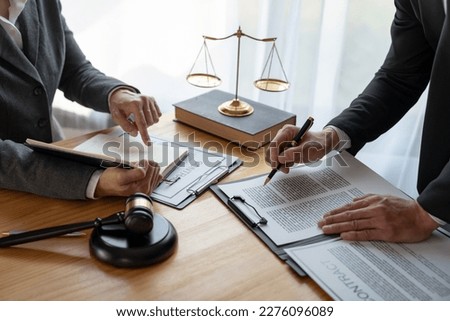 Lawyer, legal advisor, businessman brainstorming information on agreement details Business contracts in legal processing books for accuracy in contract documents. joint financial investment.