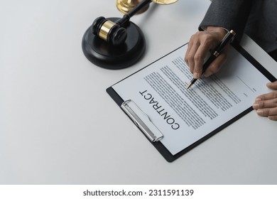Lawyer or legal advisor reading restriction law advising corporate business planning guidelines, taxation, contract signing, legality and justice concept. - Shutterstock ID 2311591139