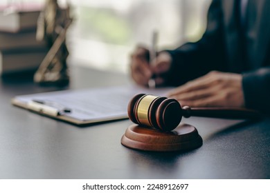 Lawyer office male working with hammer and scales with document, contract, legal adviser concept. - Shutterstock ID 2248912697