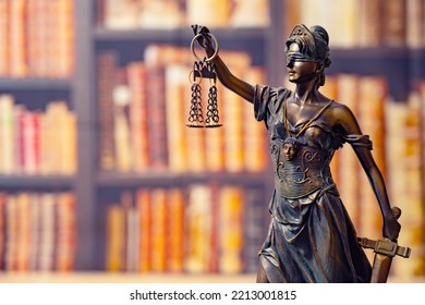 Lawyer Office. Statue Of Justice With Scales Close-up Against The Backdrop Of A Wall Of Books Or A Library . Legal Law, Advice And Justice Concept