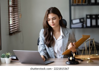 Lawyer office. Statue of Justice with scales and lawyer working on a laptop. Legal law, advice and justice concept. - Shutterstock ID 2221815367