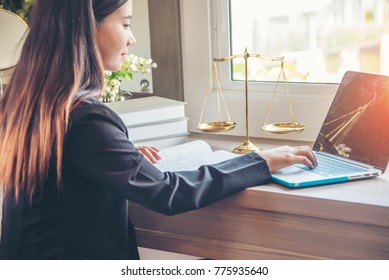 Lawyer Office. Statue Of Justice With Scales And Lawyer Working On A Laptop. Legal Law, Advice And Justice Concept.