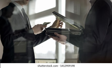 Lawyer opening case and looking at money, concept of illegal job offer, bribe