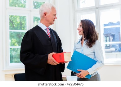 Lawyer And Paralegal In Their Law Office