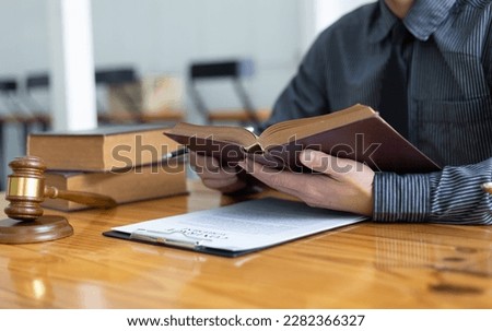 Lawyer reading a book and working in a law firm, Legal counsel and justice concept.