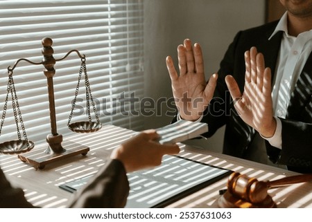 Lawyer is refusing to accept a bribe from a client, demonstrating their honesty and integrity