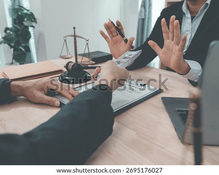 Lawyer refusing to accept bribe from client, making corrupt deal, judge's gavel, brass scales, law office, close up.