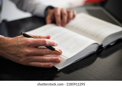 Lawyer Researching In A Law Book