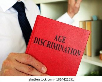 A lawyer shows an Age discrimination law book in the office.