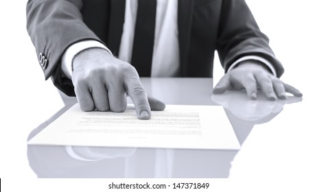 Lawyer Sitting At White Desk Showing His Client To Proof Read And Check A Statement.