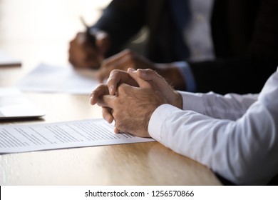 Lawyer solicitor with clasped hands consulting client about document making financial legal deal sell law services, close up view of business counselor or agreement party at contract signing concept - Shutterstock ID 1256570866
