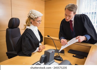 Lawyer speaking with the judge in the court room