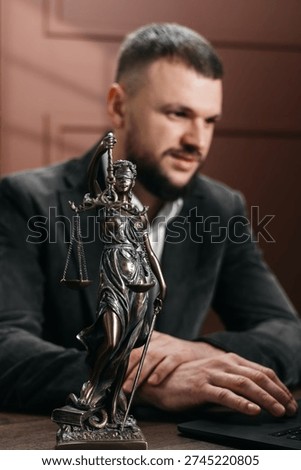 Lawyer types on a computer while examining case files, organizing information and planning legal actions.
