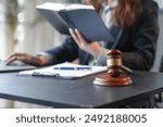 Lawyer is working at a desk with a law book and a gavel, representing the legal profession and the pursuit of justice