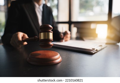 Lawyer Working With Wooden Gavel Of Judge At The Desk, Working In Laptop, With Document Contract, At Law Firm, Lawsuit And Justice Concept.