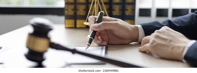 Lawyers or judges sign documents in accordance with legal and fair terms of agreement, Legal Ethics and Integrity, scales of justice, law hammer, Litigation and legal services. - Shutterstock ID 2185949881
