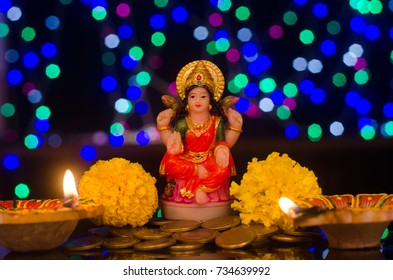 Laxmi Puja, Statue Of Goddess Laxmi, Diwali Lamp & Marigold Flowers