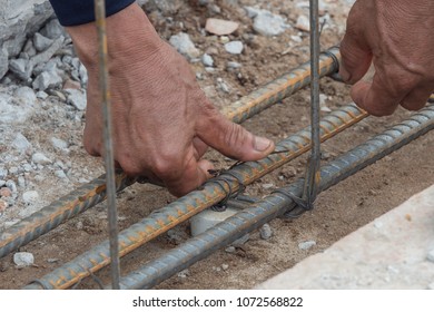 Laybor is tying steel for construction site - Shutterstock ID 1072568822