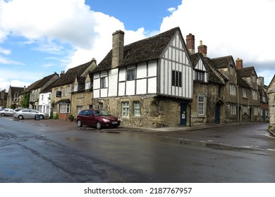 Laycock Wiltshire England. May 2022. The Half Timbered House In At The Junction Of The High Street And A Side Street. Parked Cars, No People 