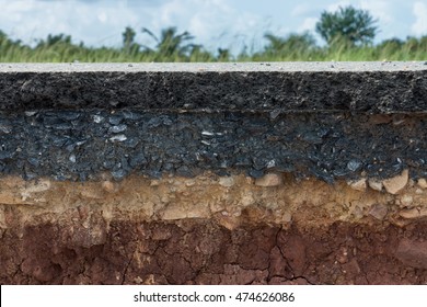 The layer of asphalt with soil and rock. Un-focus image.