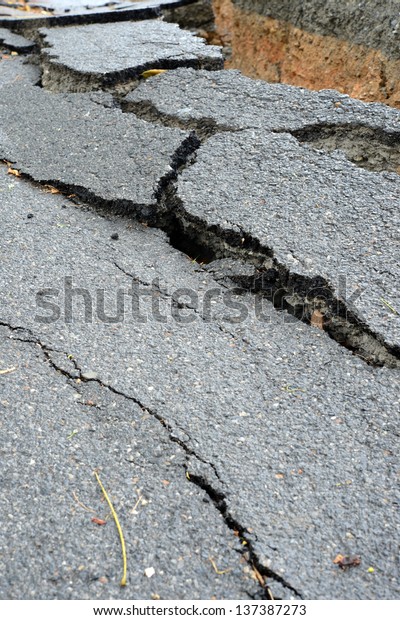 layer of broken\
asphalt road at rural\
areas.