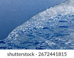 Layer of ice breaking up on the surface of Yellowstone Lake, Yellowstone National Park, WY