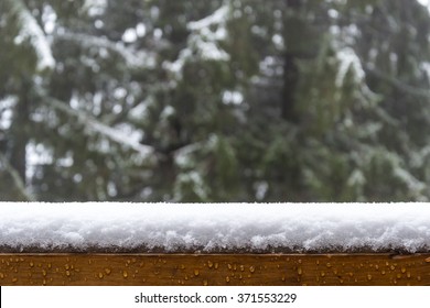 Layer of snow \ layer of snow on a fence whit trees in the background  - Shutterstock ID 371553229