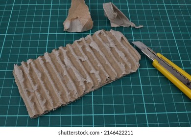 layer texture in cardboard with a cutting mat background and there is a knife