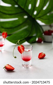 Layered Alcohol Cocktail Shot In A Glasses Decorated With Strawberry. Vodka And Strawberry Syrup. Side View. Fresh Summer Shots For Party. Bar, Restaurant Menu