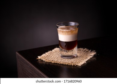 Layered B 52 Cocktail Shot On A Burlap Coaster Placed On A Bar Counter With Copy Space