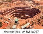 Layered deep open pit copper mine in Cobar town of Australia - aerial top down view.