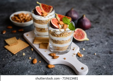 Layered Mascarpone Dessert With Crushed Vanilla Biscuits, Figs And Almonds In A Glass Jar