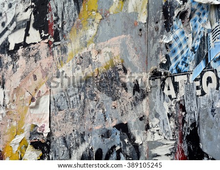 a layered texture background of torn posters and spray paint