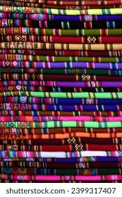 Layers of colourful patterned cloth in different colors.