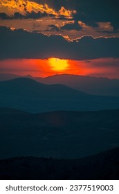 Layers of a dramatic cloudscape sky over mountains