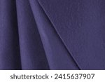 Layers of French terry lilac, dark purple, violet, charoite color fabric. Cut for sewing, footer warm textile, texture background. clothing creation, selection in a fabric store