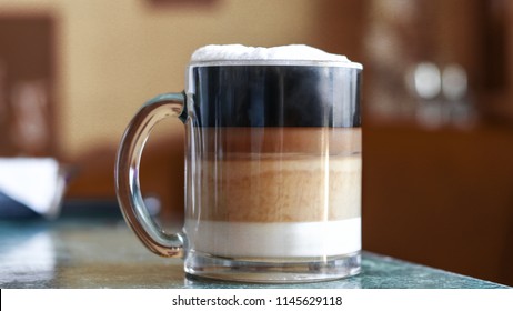 layers of latte 
in a cup with milk coffee and alcohol 
whiskey