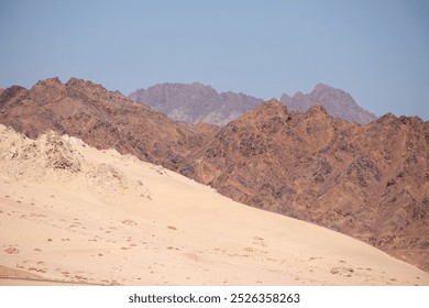 Layers of mountains positioned behind each other, each displaying unique shades of yellow, creating a stunning and vibrant natural landscape