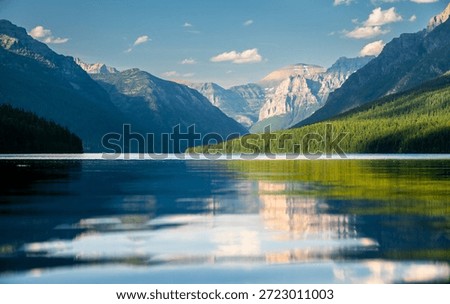 Layers Of Moutains and Cliffs Tower Over The Back Of Bowman Lake In Glacier National Park