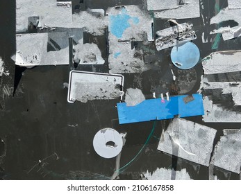 Layers of ripped off street wall stickers, torn creative ghetto flyer background 