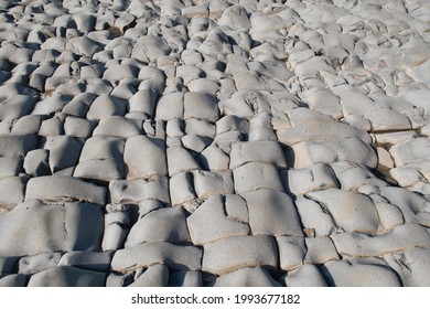 Layers Of Sedimentary Rocks Make Interesting Patterns On The Beach At East Quantoxhead Beach Near Kilve, Somerset, England. Beautiful Old Rocks. Ocean Floor.