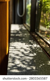 Layers of sheer curtains drape the windows, revealing glimpses of the green park scenery and pedestrians outside. Dappled sunlight filters through, creating a soft, impressionistic atmosphere and showcasing the details of a poetic dining environment.