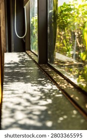Layers of sheer curtains drape the windows, revealing glimpses of the green park scenery and pedestrians outside. Dappled sunlight filters through, creating a soft, impressionistic atmosphere and showcasing the details of a poetic dining environment.