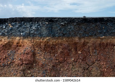 The layers of soil and rock of road with sky background. - Shutterstock ID 1589042614