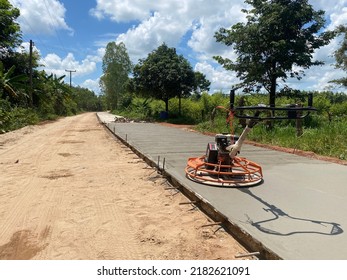 Laying Down New Road In Wet Concrete On Freshly Poured Road