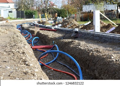 Laying a fiber optic cable for fast internet, Electricity and telephone cable along a new street. Cable Installation power lines at city street, industrial electricity and communication concept.
